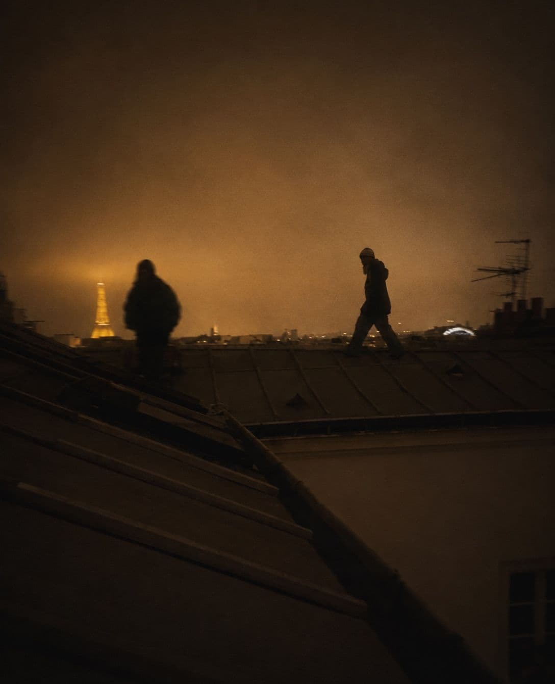 two silhouettes on a roof and a city that didn't need you anywhere.