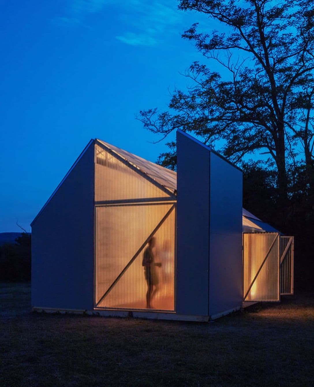 a small house that glows from the inside once the sky goes blue.